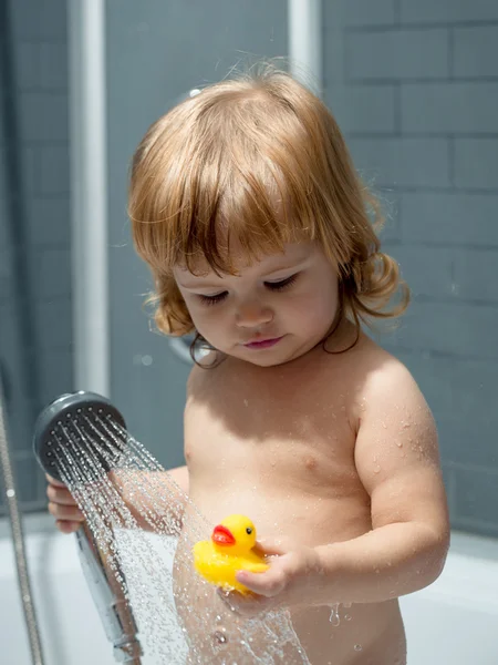 Boy with duckling in bath — Stock Photo, Image