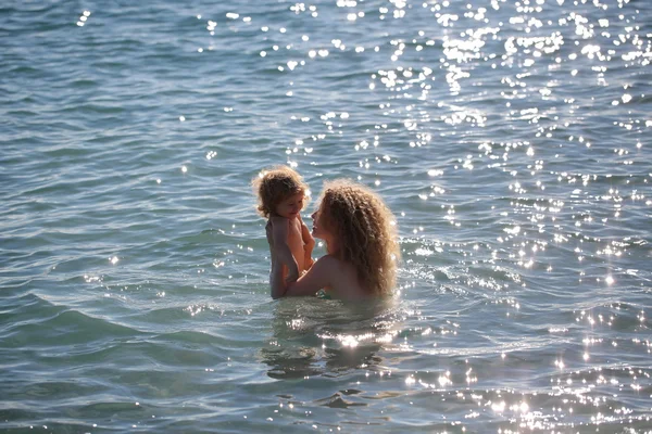 Woman in bikini with child — Stock Photo, Image