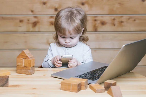 Menino pequeno com computador e telefone — Fotografia de Stock