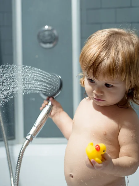 Boy with duckling in bath — Stock Photo, Image