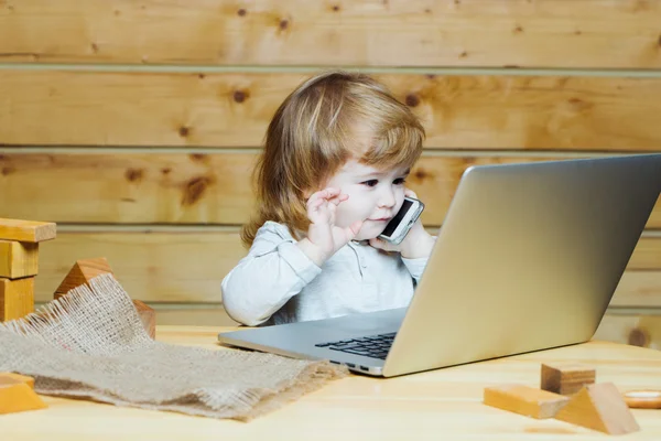 Small boy with computer and phone