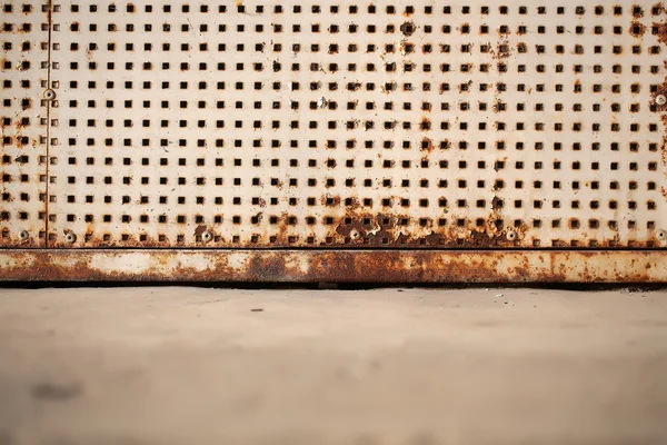 Rusty plate with square holes — Stock Photo, Image