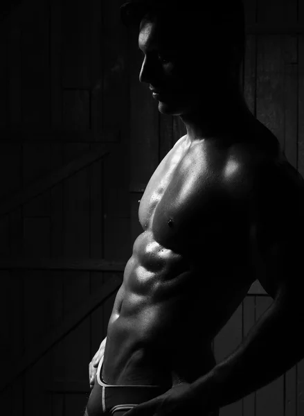 Silhouette of young muscular man