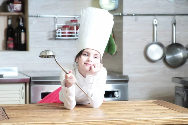 Girl in kitchen with ladle — Stock Photo, Image