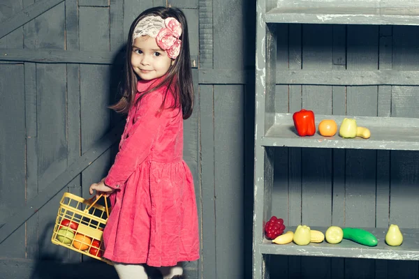 Small girl with plastic food — Stock Photo, Image