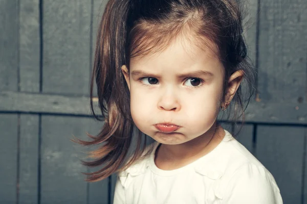 Small girl making faces