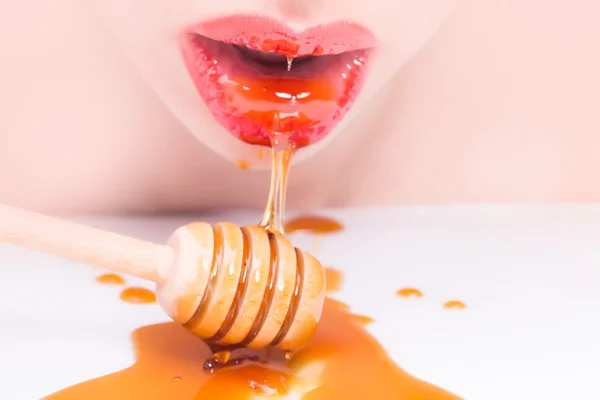 Female lips with honey — Stock Photo, Image