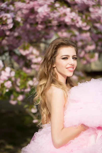 Happy girl in pink blossom — Stock Photo, Image