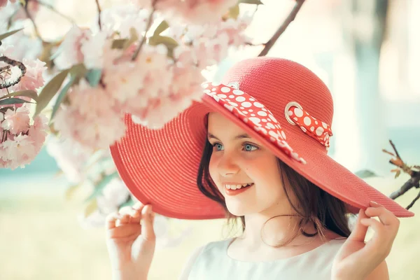 Girl in hat with bloom — Stock Photo, Image