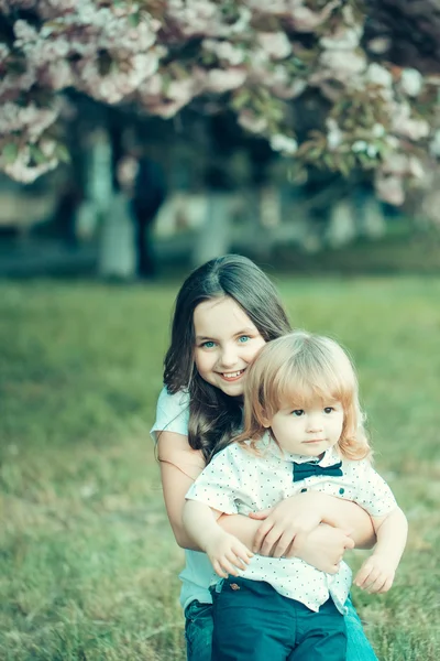 Happy children in orchard — Stock Photo, Image