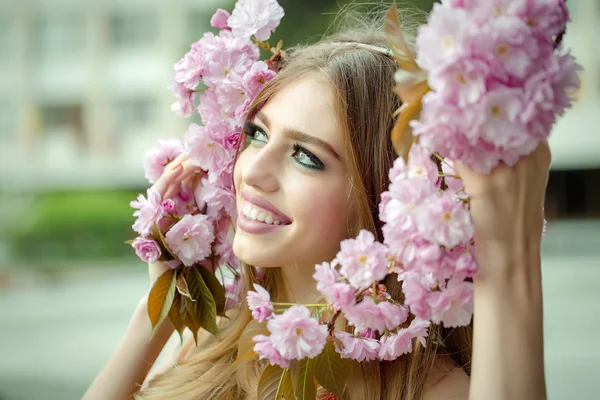 Beautiful young woman with twig — Stock Photo, Image