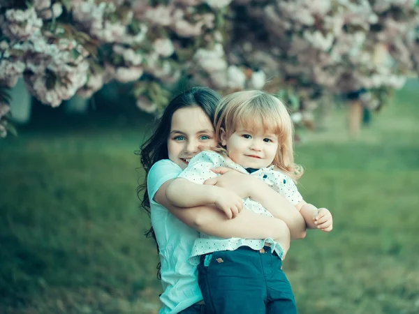 Happy children in orchard — Stock Photo, Image