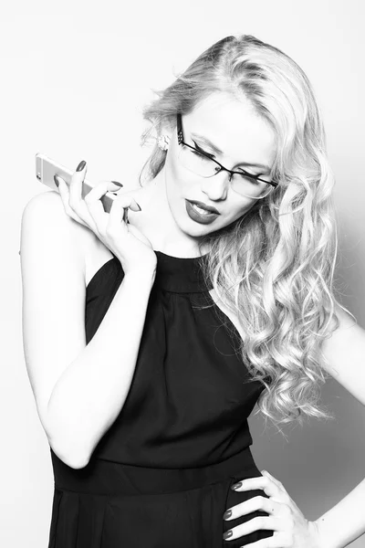 Sexy blonde in glasses with phone — Stock Photo, Image