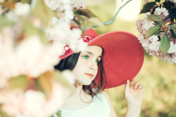 Girl in hat with bloom — Stock Photo, Image