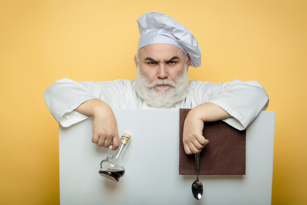 Bearded cook with paper