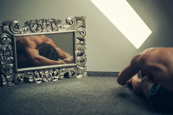 Young man in silver mirror — Stock Photo, Image