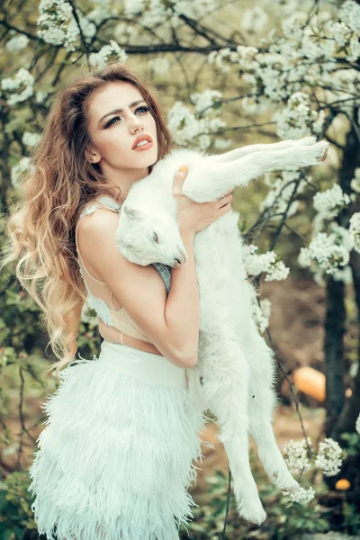 Woman with goat in blossom — Stock Photo, Image