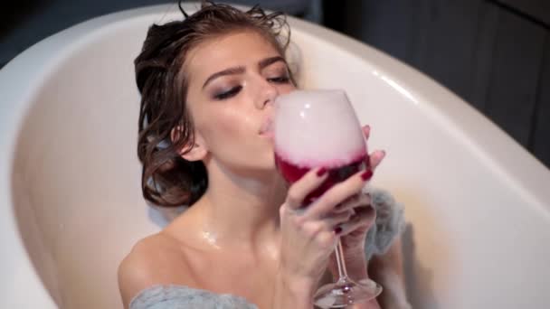 Girl is blowing a glass of wine — Stock Video