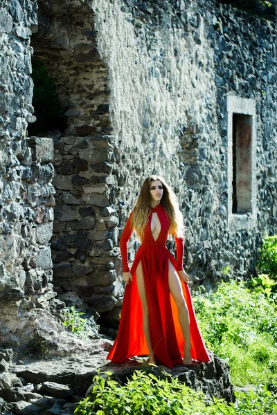 Sexy woman in red dress in ruins — Stock Photo, Image