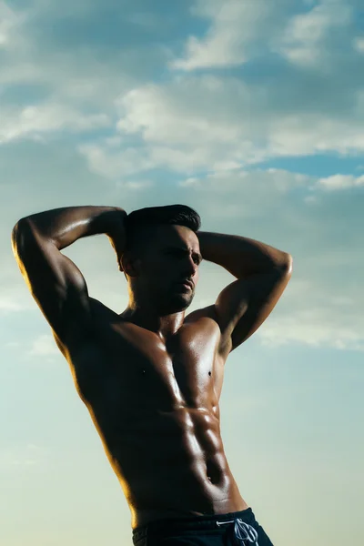 Sexy musculoso hombre en el cielo fondo — Foto de Stock