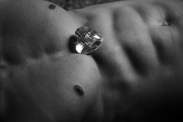 Muscular torso with heart gemstone — Stock Photo, Image