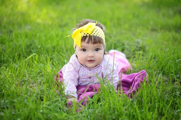 Cute baby girl on green grass — Stock Photo, Image