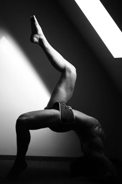 Muscular yoga man in bridge position — Stock Photo, Image