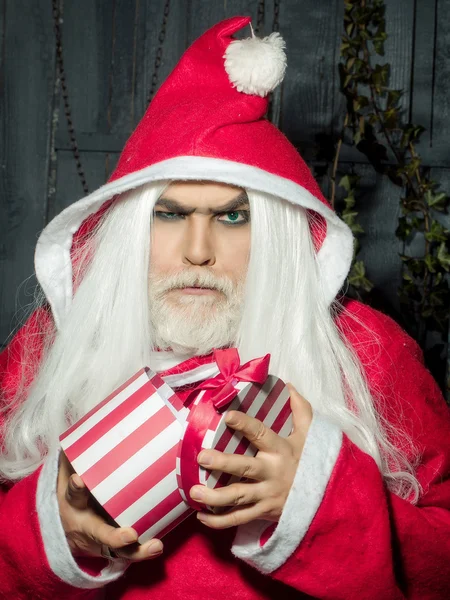 Uomo di Natale serio con regalo — Foto Stock