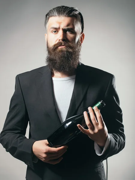 Bearded man with wine bottle — Stock Photo, Image