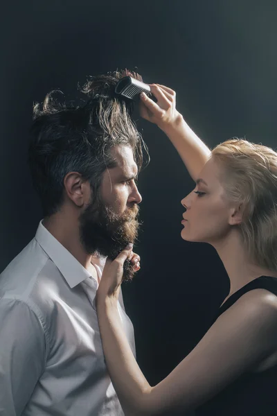 Blonde hairdresser combing bearded man — Stock Photo, Image