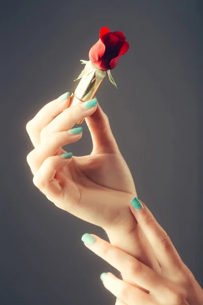 female hands with red rose