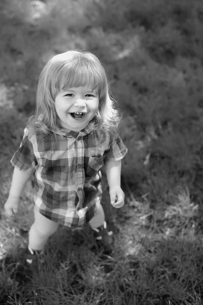 Happy small boy on grass — Stock Photo, Image