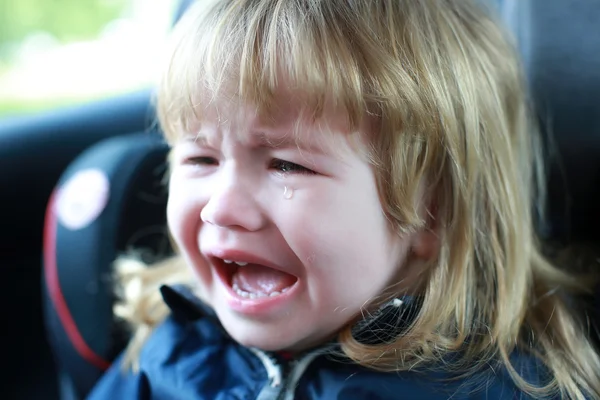 Маленький мальчик плачет в машине — стоковое фото