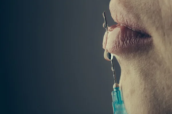 Woman with syringe in hand — Stock Photo, Image