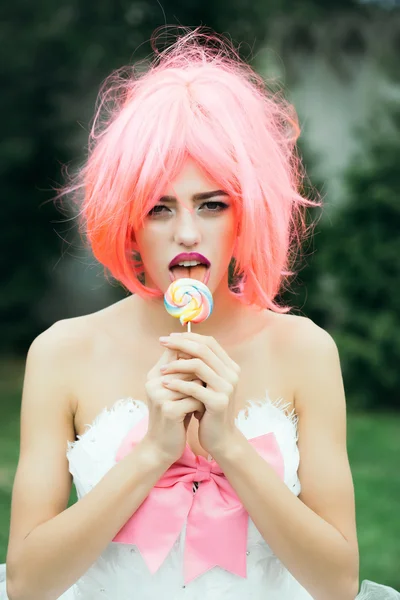 woman with orange hair lick lollipop