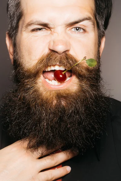 bearded man with red cherry