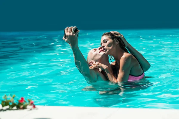 幸福的年轻夫妇，在游泳池里 — 图库照片