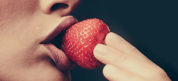 Female lips eating red strawberry Stock Picture
