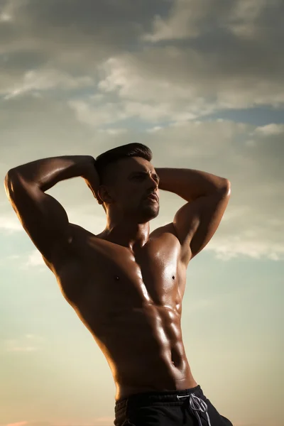 Sexy muscular man on sky background — Stock Photo, Image