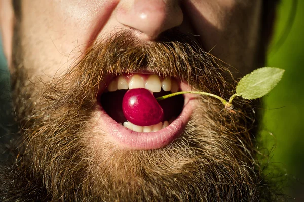 bearded man with red cherry