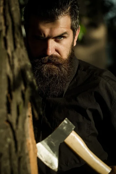 Bearded man outdoor with axe — Stock Photo, Image