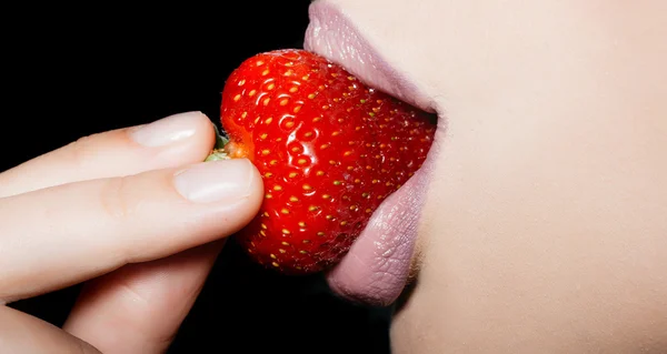 Female lips eating red strawberry Stock Image