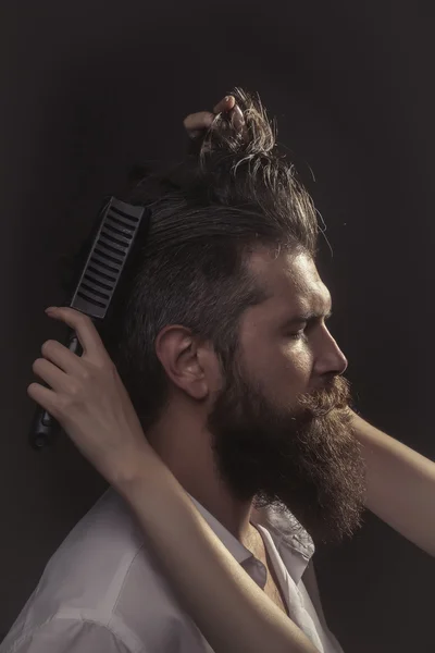 Жіноча рука розчісує бородатого чоловіка — стокове фото