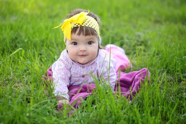 Cute baby girl on green grass — Stock Photo, Image