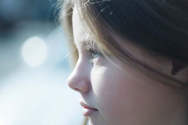 Beautiful young girl closeup with thoughtful face sunny day outdoor