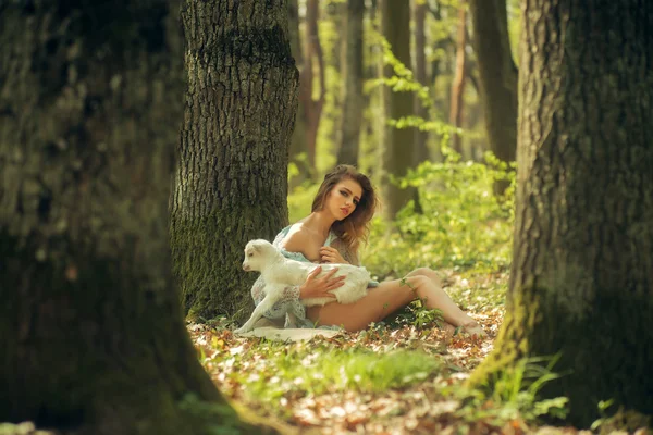 Young woman with goat in forest — Stock Photo, Image