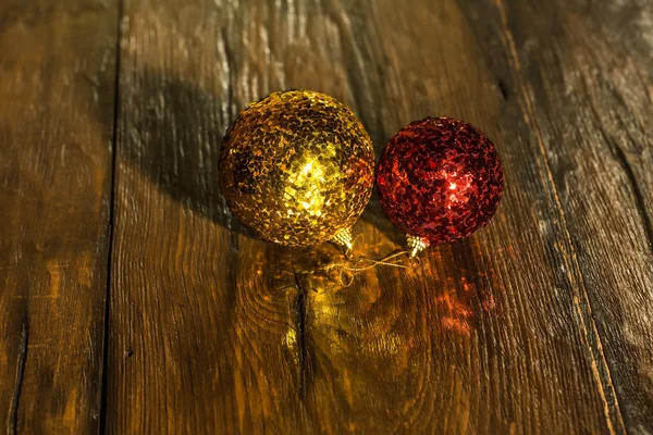 Christmas glittering balls on the wooden surface