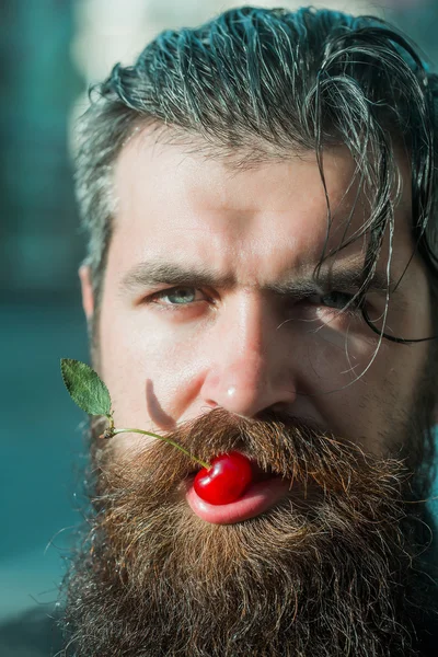 bearded man with red cherry