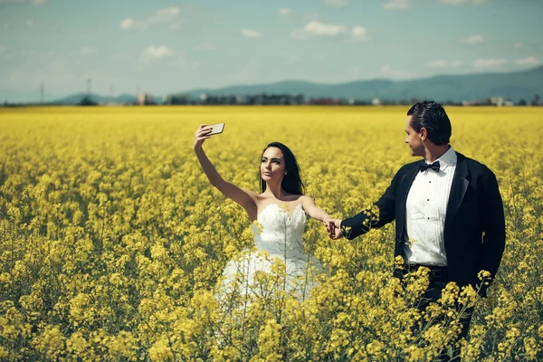 wedding couple in field yellow flowers