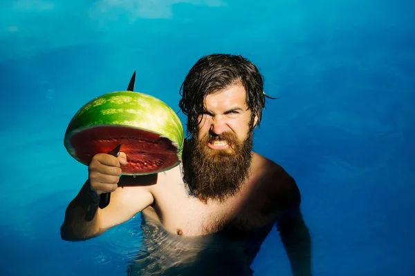 Man with watermelon and knife in pool — Stock Photo, Image